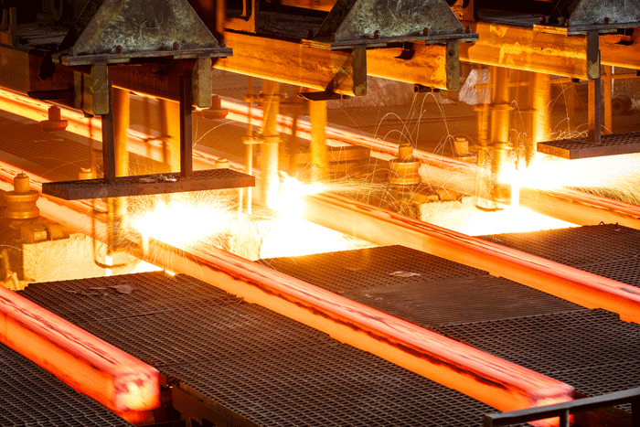 Steel bars being cut with torches in a factory operation